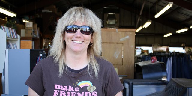 Heather Lorio, owner of Elbe Gray's Thrift Shop in Craig, sits behind the open back door to the store. Lorio says she hopes to operate her thrift store as a nonprofit soon and currently donates unsold books, winter coats and other merchandise to senior centers, jails and other assistance-based organizations in the area.