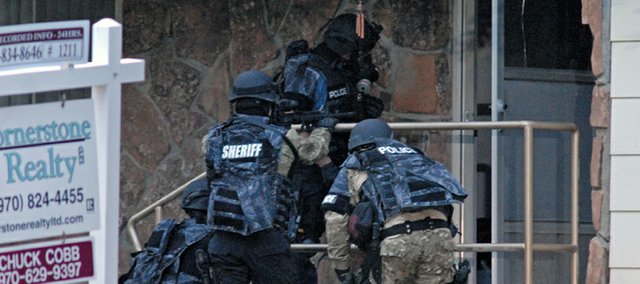 Members of the joint Craig Police Department and Moffat County Sheriff's Office Special Response Team prepare Monday to enter the home of Craig resident Geoffrey Ward Mansfield,39, suspected of being involved in a domestic violence incident. Mansfield barricaded himself in his home at the corner of Rose and 8th Streets, and was taken into custody after a two-hour long standoff with law enforcement officers.