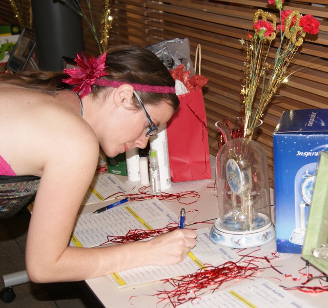 Tricia Vaughn, a second year student at Colorado Northwestern Community College's Craig campus, places her bid for an item during the silent auction portion of the CNCC Foundation Fundraiser dinner. Almost $4,000 was raised between the silent and live auction items, which will go to help build residential facilities at the Craig campus.