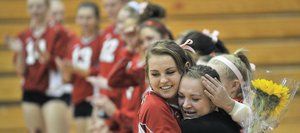 Steamboat Springs' Alex Feeley, left, hugs fellow senior Nikki Fry, who has been injured this season, during senior night at the Steamboat Springs High School gym. The Sailors recognized Feeley, Fry and Emily Spiess at the start of the game against Middle Park.