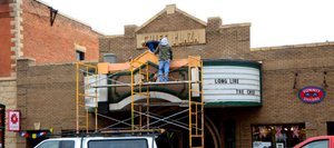 Work is done on a temporary fix to some stucco that fell from the Chief Theater's marquee. Friends of the Chief, the nonprofit that bought the theater, plans to open a temporary theater while fundraising continues for a modern performing arts venue.