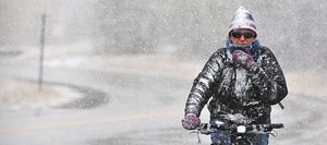 Steamboat Springs resident Annette Seiler rides her bike home from work Wednesday afternoon in Steamboat Springs. Snow flurries greeted pedestrians, cyclists and motorists in downtown Steamboat as the first winter storm of the season arrived as scheduled.