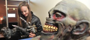Zsa Zsa Zahourek checks out a stockpile of scary hands for the custom she plans to wear for this year's Screamboat Chamber of Horror. The haunted house, a fundraiser for the SKY Club, will open at 6 p.m. Friday inside the campus's new auditorium.