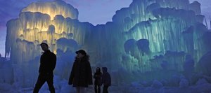 Emily Banville, 11, second from left and her father, Mike, left, of Englewood, begin a tour of the illuminated ice castles in Silverthorne last winter. The creators will be growing a similar structure in Ski Time Square this winter, one of only two they're making in the world this year. The other ice castle will be at the Mall of America.