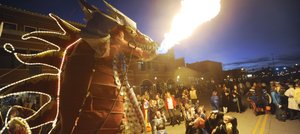Steamboat Springs resident Charlie Holthausen's dragon spits fire during the Downtown Halloween Stroll on Wednesday night in Steamboat Springs. During breaks from trick-or-treating, kids lined up for the chance to make the 35-foot fire-breather come alive.