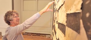 Local artist Cindy Wither talks about how a piece, shown in the background, by local artist Gregory Block inspired her own work for the Steamboat Springs Arts Council's "Reconstruction" show.