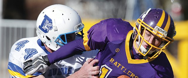 Little Snake River Valley School senior Cole Gourlay is brought down by Sterling Baker (44) of Dubois High School during the Wyoming 6-man state championship game. Friday at War Memorial Stadium in Laramie, Wyo. The Snake River Rattlers were going for three straight titles, but Dubois won the game, 54-30.