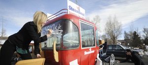 Steamboat Springs Chamber Resort Association employees Morgan McDougald, right, and Maren McCutchan spruce up the Chamber’s gondola carriage that will be featured in the Houston Holiday Parade on Thanksgiving Day.
