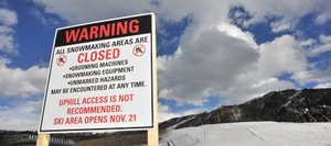 Signs are set up at Steamboat Ski Area warning skiers about snowmaking operations and cautioning them about potential dangers of making the trek up the mountain for a few early season turns. Citing an effort to promote skier safety, ski area officials are asking those uphill upstarts to read through a list of dangers and don a free reflective armband made available by the ski area.