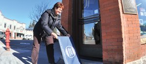 Mainstreet Steamboat Springs Manager Tracy Barnett puts doormats out in front of downtown businesses that are participating in "Sweet Treats on MainStreet" on Saturday as a part of a larger event, Small Business Saturday, which was started by American Express to promote shopping locally.