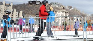 Beginner skiers ride a magic carpet at Steamboat Ski Area on Thursday, the first day season passes were accepted. With as much mud around as snow, it definitely was a "make the most of it" kind of day and plenty did.