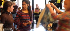 Sisters Catherine Onate, right, and Nicole Onate check out at downtown retailer Urbane on Friday afternoon. Business owners reported brisk business Friday as many offered special Black Friday deals.