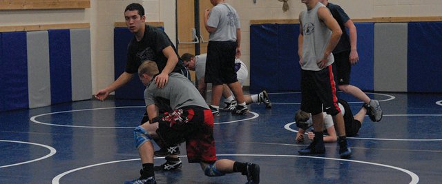 Jacob Teeter (in black) and Garrett Stewart (bottom) work on take-down moves Thursday during Moffat County High School wrestling practice. Both seniors went 4-1 in their first weekend of wrestling over the weekend at Colorado Mesa University in Grand Junction. MCHS heads back to Grand Junction Saturday for more duals.