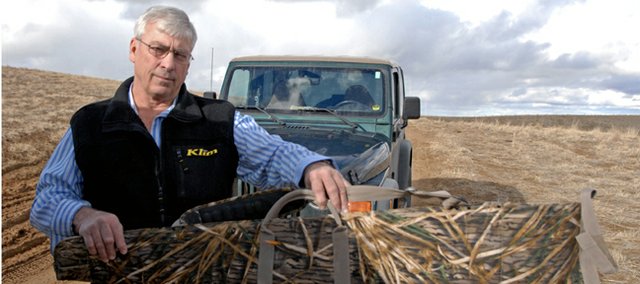 Dan Rast holds up his son, Tyler's, soft gun case. The yellow pencil marks the location where a bullet, presumably meant for a mule deer doe, pierced the gun case, traveled through the tiny window between the scope and the breech of the rifle, and struck Tyler in the arm. The nonfatal accident took place in November while Dan and Tyler were hunting mule deer in GMU 3.