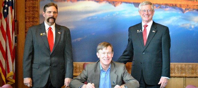 Senate District 8 Sen. Randy Baumgardner, R-Cowdrey, left, and House District 57 Rep. Bob Rankin, R-Carbondale, right, pose with Gov. John Hickenlooper during the signing into law of House Bill 13-1203. The measure, carried by Rankin and sponsored by Baumgardner, eliminates the requirement of political subdivisions of the state to submit certain reports on an annual basis.