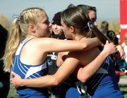 Moffat County junior Laura Zirkle, left, gets in on a group hug with teammates junior Alicia Nelson, foreground, and senior Caitlin Conci after the 2007 Class 4A State meet in Colorado Springs. The girls finished ninth, led by Nelson's fourth-place finish.