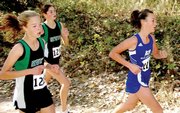 Moffat County freshman Nike Cleverly races in front of two Niwot runners with less than a mile to go at the Class 4A State Cross Country Championships Saturday in Colorado Springs. Cleverly was the team's third runner and finished in 85th place.