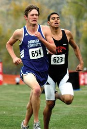 Moffat County senior Mike McNicol gives it his all as he tries to stay in front of a Greeley West runner at the finish of Saturday's 2007 Class 4A State meet. McNicol led the Bulldogs boys to a 22nd-place finish with his own 28th-place finish.