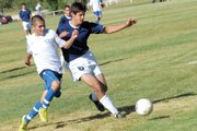Rifle's Drew Marlow fights against Moffat County High School's defense Tuesday in Craig. The Bears scored twice in the second half for a 3-1 win in their Western Slope League opener.