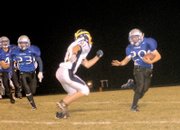 Moffat County's Jasen Kettle tries to get outside in the second quarter of the Bulldogs' game against Rifle.