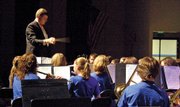The baton flies as director John Bolton leads the Eighth Grade Concert Band, from Craig Middle School, in "The Parade of the Bumbling Wooden Soldiers" on Tuesday night in the Moffat County High School auditorium. The Moffat County High School Concert Band, CMS Seventh Grade Concert Band and CMS Eighth Grade Jazz Ensemble also performed at the concert.