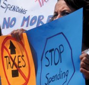 Linda Behrman, of Craig, looks out from behind her signs at the traffic coming down Victory Way. Organizers plans to put together a similar demonstration in early May. For more information, call Rick Barnes at 824-6991 or e-mail dont_treadonme@hotmail.com.
