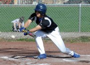 Spencer Wayman bunts during the first game of the doubleheader Tuesday against visiting Rifle. The Bulldogs' offense didn't warm up soon enough as late rallies fell short in both games, 9-4 and 11-6, against the Bears.