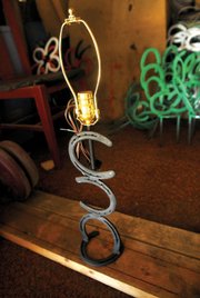 Lee Hoth said his best-seller is the horseshoe lamp. He creates many different things, however, including picture frames, Christmas cacti, wall lamps, crosses, butterflies, flowers and lawn ornaments.