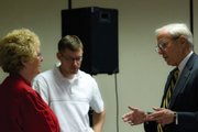 University of Colorado President Bruce Benson talks with Audrey Danner, left, and Cole White, middle, at Tuesday's Rotary Club meeting at the Holiday Inn. The stop was part of an outreach tour for Benson to connect with Colorado residents.