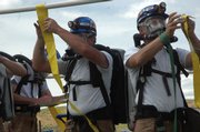 Two members of the West Elk Mine rescue team close off an "airlock" in a simulated mine. Twenty teams from Colorado and Utah are competing in a mine rescue competition this week at Moffat County High School.