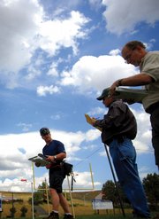 Ray Mazzola, left, participates in the 18th annual Mine Rescue, First Aid, Bench & Pre-Shift Contest at Moffat County High School while judges Peter Saint, center, and Barry Grosly, right, evaluate his work. Twenty teams from Colorado, Utah, New Mexico and Wyoming participated in the event.