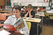 Joseph Selbach, front, 11, and Matthew Moschetti, 11, read during David Gaines' fifth-grade class Thursday at Sandrock Elementary School. Gaines earned his master's degree in contemplative education and completed a thesis on using silence as a tool for empowerment and reflection in the classroom.