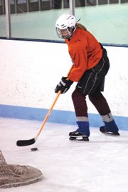 Kelsie Pomeroy receives the puck behind the net during a recent Moffat County Bulldog Club Hockey Team practice. Pomeroy is the only girl on a team of more than 20 players. This season is the first time she has been the only girl on a team.