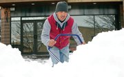 Aurelio Barraza, of John's Construction, removes snow from in front of Mahogany Ridge Brewery & Grill on Wednesay morning.