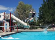 Samuel Walls, 10, does a back flip off the diving board during a sunny Friday at the Craig Swimming Complex. Walls just finished fourth grade at Sandrock Elementary School and said he’s happy to enjoy the summer.