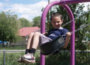 Everett Colvin, 6, plays on the swing set Friday at Craig City Park. Colvin was playing with his father and friends at the park, and will be heading to first grade at East Elementary School in the fall.