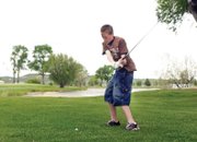 Gage Hall, 16, takes a swing at the fifth green Thursday at the Yampa Valley Golf Course. Hall said he and his friends have played a round of golf every day since school let out last week.
