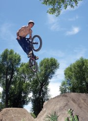 Kelly Campbell, 15, soars over a gap on the step-down jump Friday at Sherwood Forest. Campbell, on his way to being a high school freshman, also helped his friends build lips to maintain safe jumps.