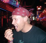 Andrew Christensen eats a cricket in Thailand while on a three-month trip through Africa and Asia. Crickets, cockroaches and beetles are commonly eaten in Eastern Asia.