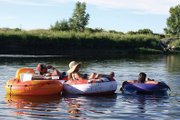 Dave Robinson, left, Libby Beach, middle, and Cyndi Arnett float down the Yampa River on Saturday past Loudy-Simpson Park. Boating and tubing down the river is an inexpensive way for many area residents and visitors to cool off in the summer heat.