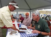 Matt Provost, left, shows a plate of brisket to judge Terry Conci during the Colorado BBQ Championship on Saturday at Wyman Museum. Food was judged based on appearance, tenderness and taste.