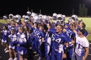 The Moffat County High School football team and cheerleaders sing their victory song after beating Kennedy High School in the final minute Friday at home. A Zach Raftopoulos fumble recovery sealed the win for the Bulldogs.