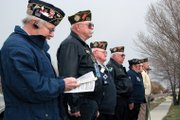 Members of Veterans of Foreign Wars Post 4265 participate in a flag dedication ceremony Saturday at Thunder Rolls Bowling Center in Craig.