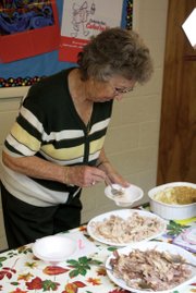 Joann Stoddard serves herself turkey Sunday during the annual Thanksgiving dinner at the First Congregational United Church of Christ. A 28-pound turkey served all members of the congregation, plus several members of the community.
