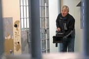 Freelance photographer Carl Filoreto frames a shot within a holding cell where Steven Hatch and Glen Ake were held. The Dateline NBC special about the fugitives’ case could air early next year.