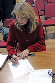 Jean White signs her designation of nomination by the vacancy committee Monday at the Moffat County Courthouse after being selected to replace her husband, Al, in the state senate. Al was recently chosen to lead the Colorado Tourism Office and will step down from the senate on Jan. 11.
