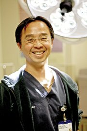 Dr. Tinh Huyn stands in a trauma room within The Memorial Hospital’s emergency room. Huyn recently accepted a full-time position at the hospital after working for more than a year as a temporary physician.