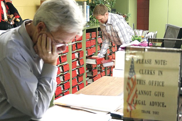 Craig attorney Tom Thornberry, left, and Peter Gabel, right, browse information Wednesday inside the Moffat County Clerk and Recorder’s office. The office has been consistently busy with landmen reviewing records stemming from oil drilling interest in the area since October 2010. Since then, the average price of mineral leases has gone up and more local ranchers are leasing their land.