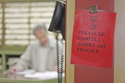 A sign asking landmen to be careful with the county’s real estate record books hangs inside the Moffat County Clerk and Recorder’s office. The six months of consistent use of the books has contributed to considerable wear and tear, county clerk Lila Herod said. The Moffat County Commission recently approved spending $15,000 to repair 60 of the more than 600 books in the office.