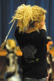 Callie Papoulas, a Moffat County High School senior, practices accuracy March 8 in the East Elementary School gymnasium. Along with fellow senior Nike Cleverly, Papoulas will try to lead the MCHS girls varsity golf team to a second consecutive 4A state championship meet.